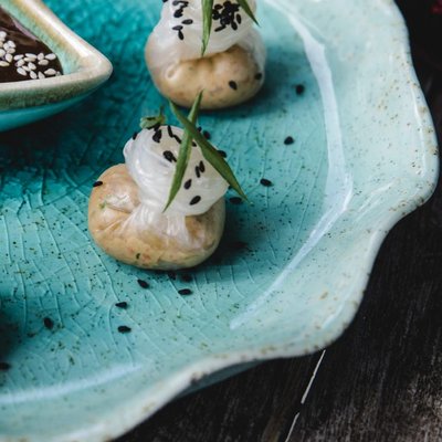 Appetizing dumplings on blue plate
