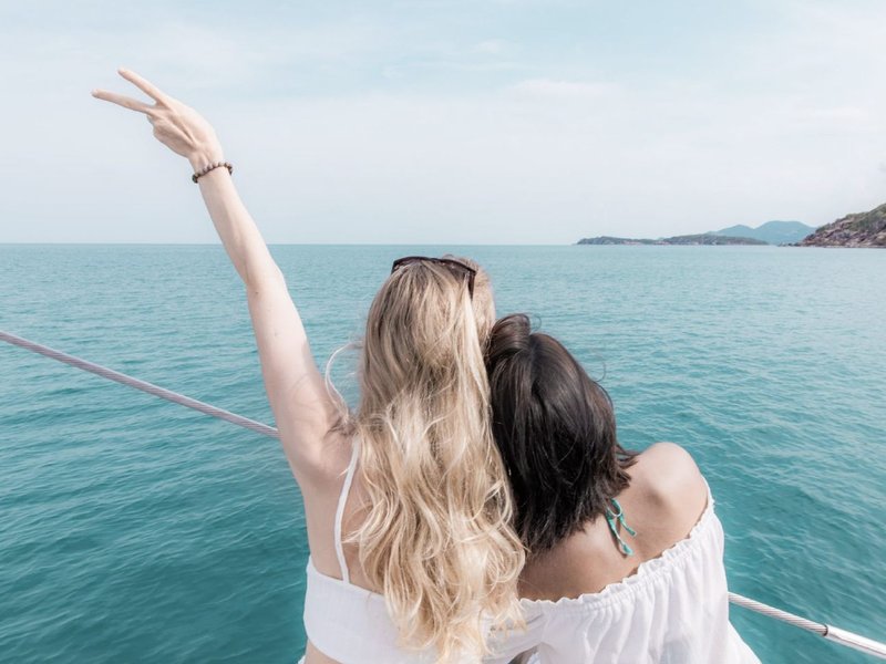 Two women enjoying a sunset boat cruise in Koh Samui